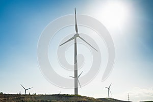 Wind turbine generating electricity with blue sky - energy conservation concept