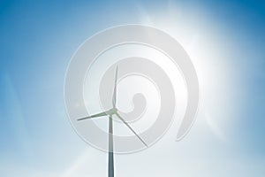 Wind turbine generating electricity with blue sky - energy conservation concept