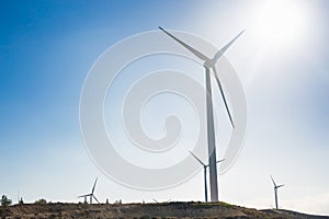 Wind turbine generating electricity with blue sky - energy conservation concept