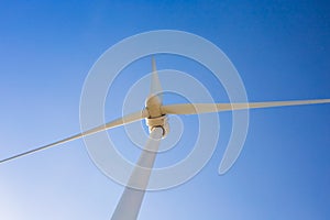 Wind turbine generating electricity with blue sky - energy conservation concept