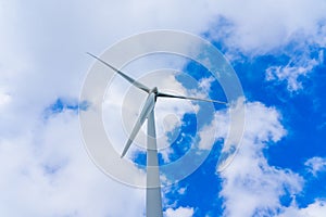 Wind turbine generating electricity clean energy with cloud and sunlight background on the sky. Clean energy concept.