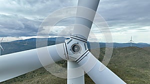 wind turbine generating electricity on mountain top in cloudy weather