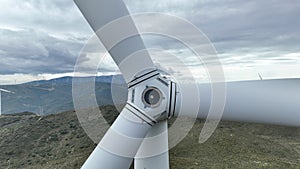 wind turbine generating electricity on mountain top in cloudy weather