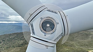 wind turbine generating electricity on mountain top in cloudy weather