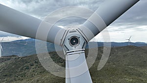 wind turbine generating electricity on mountain top in cloudy weather