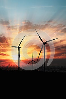 Wind turbine generating electricity on sky sunset background .