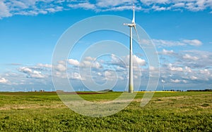 Wind turbine on grassy field