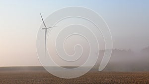 Wind turbine in the mist at dawn