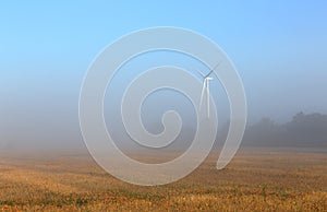 Wind turbine in the mist at dawn