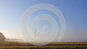 Wind turbine in the mist at dawn