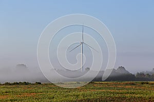 Wind turbine in the mist at dawn