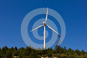 Wind turbine over the blue sky