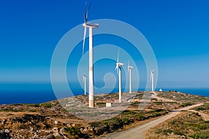Wind turbine power generator farm  on a hillside