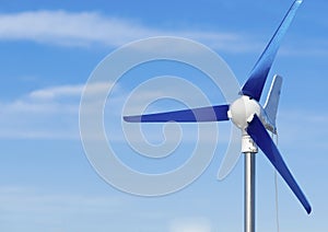 Wind turbine producing alternative energy renewable power on blue sky