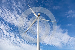 Wind turbine, renewable energy on blue cloudy sky background