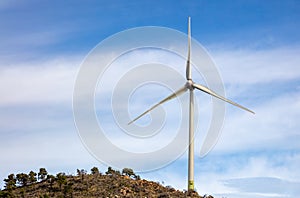 Wind turbine, renewable energy on a rocky hill