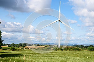 Wind turbine in rolling rural landscape in summer