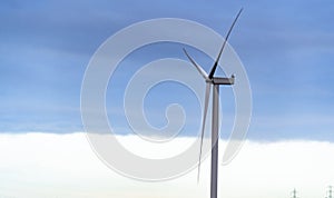 Wind turbine shot against a dark stormy skyline