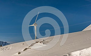 Wind turbine and snow in the Alps, Switzerland