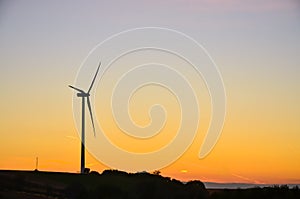 Wind turbine during sunset. Eclogy photo