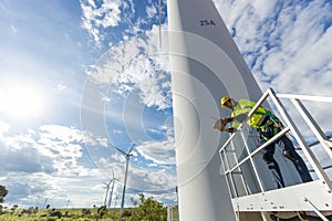 Wind turbine technician checking service. Engineer team professional working maintenance clean power generator system