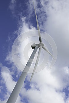 Wind turbine under cloudy sky