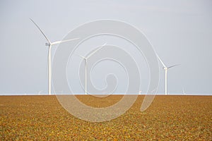 Wind turbines against the backdrop of a cloudy sky, windmills that generate electricity are installed in the steppe