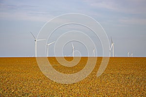 Wind turbines against the backdrop of a cloudy sky, windmills that generate electricity are installed in the steppe