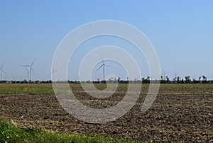 Wind turbines and agricultural field. Energy production, clean and renewable energy