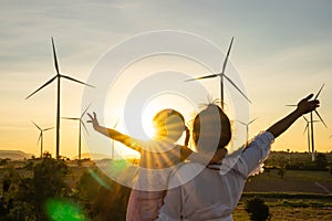 Wind turbines are alternative electricity sources, the concept of sustainable resources, People in the community with wind