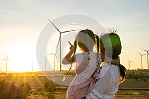 Wind turbines are alternative electricity sources, the concept of sustainable resources, People in the community with wind