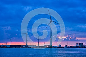 Wind turbines in Antwerp port in the evening