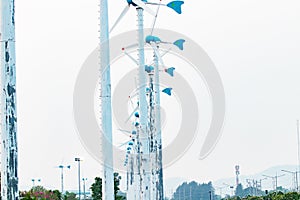 Wind turbines arranged in rows with bright sunlight. Windmill or also small on wind in port at Thailand