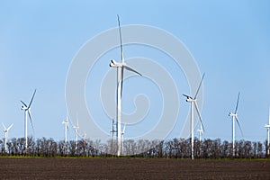 Wind turbines on an autumn or spring field