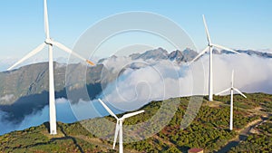 Wind turbines in a beautiful sunny place in the mountains in autumn. Green energy production. Wind farm in an ecological field