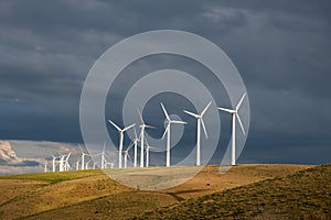 Wind turbines below a stormy sky