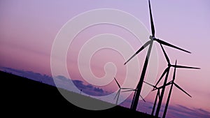 Wind turbines in the countryside under a beautiful sunset