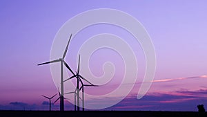 Wind turbines in the countryside under a beautiful sunset