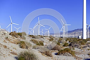 Wind turbines creating renewable energy on windfarm