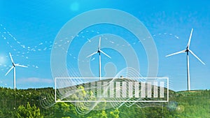 Wind turbines with digital visualization of wind and battery charge against blue sky. Concept of green renewable energy.