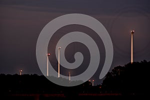 Wind turbines at dusk, blades look like wheels