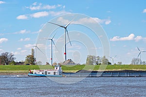 Wind Turbines on the Elbewith Cargo Vessel in Lower Saxony