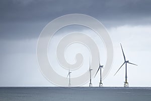 Wind turbines at electric power farm in the North Sea in Aberdeen for renewable energy production and environment conservation