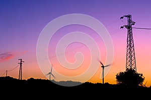 Wind turbines and electricity pylons silhouettes