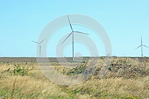 Wind turbines energy converters on the nature background