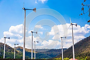 Wind turbines farm eco field in bright day with blue sky background at Chang Hua Man Royal Projects