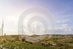 Wind turbines farm on mountanis landscape against blue sky with clouds background,Windmills for electric power ecology concept