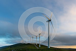 Wind turbines farm at sunrise, Oiz mountain, Basque Country, Spain photo