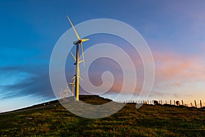 Wind turbines farm at sunrise, Oiz mountain, Basque Country, Spain photo