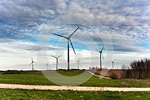 Wind turbines farm on sunset in spring